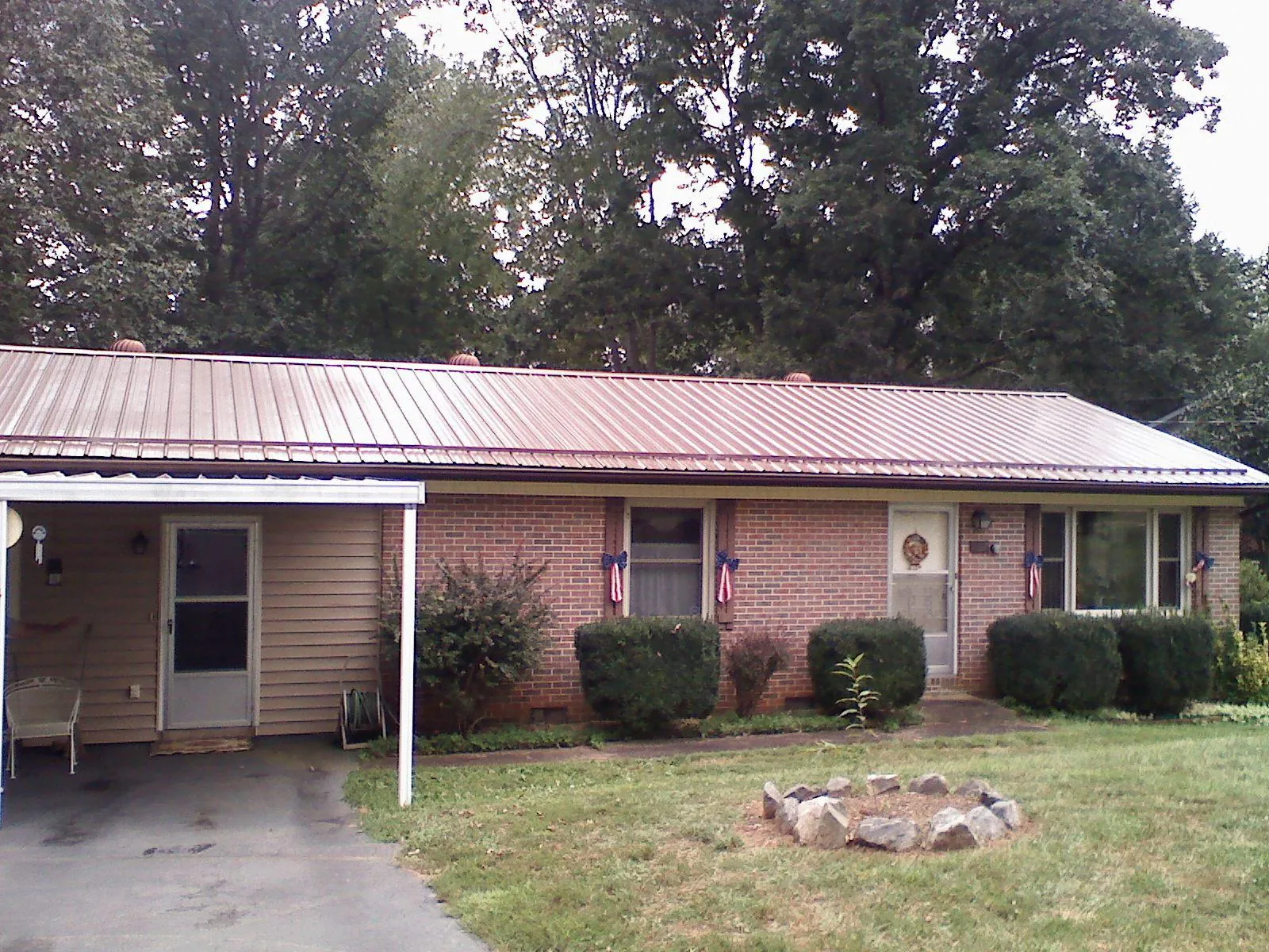 Bronze metal roof and carport on a brick ranch home — Roof Repair work by our crew in Western Springs